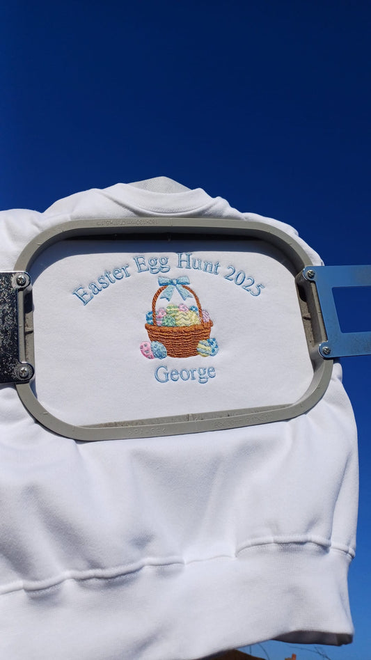 White shirt with 'Easter Egg Hunt 2023' and 'George' text and design on a blue background