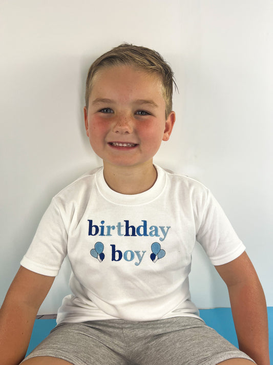 Boy wearing an embroidered birthday boy t-shirt