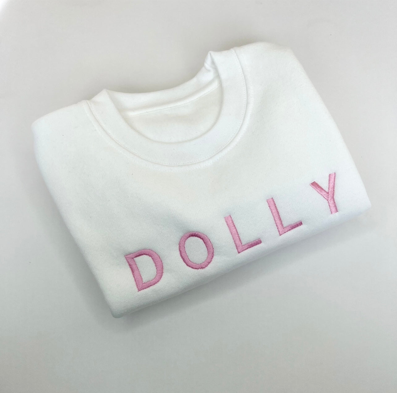 White jumper withPink Font