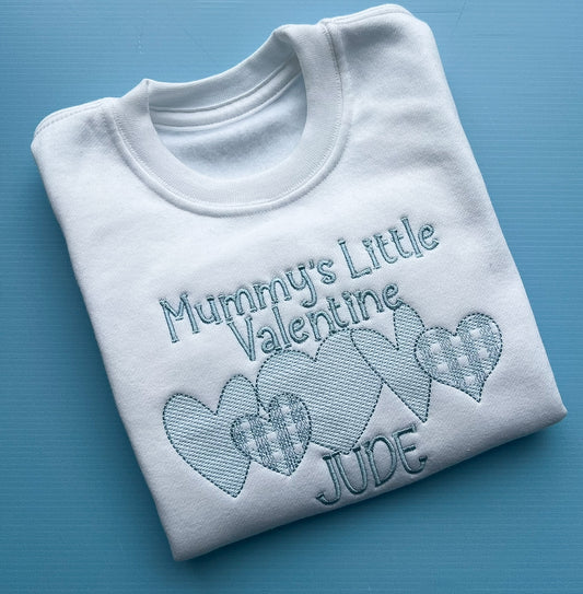 White sweatshirt with mummy’s little valentines embroidered in blue finished with a row of detailed hearts and the name Jude