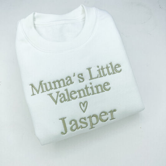 White baby romper with 'Mumma’s Little Valentine Jasper' text on a light gray background