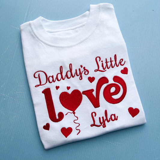 White t-shirt with red text 'Daddy's Little Love Lyla' on a blue background