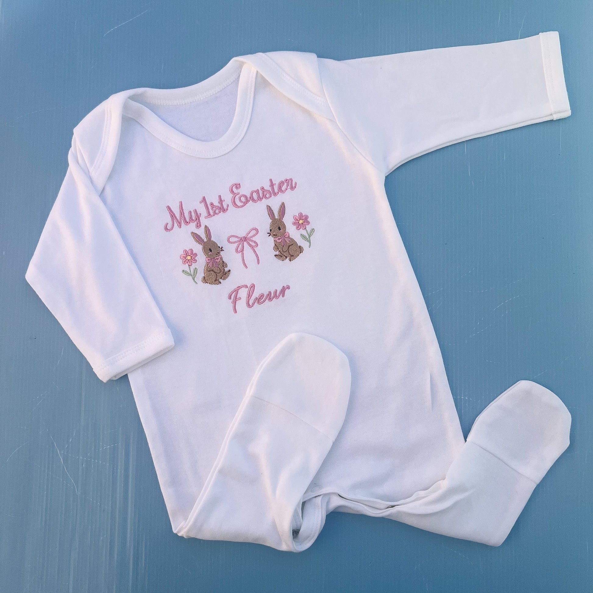 Baby romper with my first Easter embroidered in pink with a bunny, bow and some flowers 