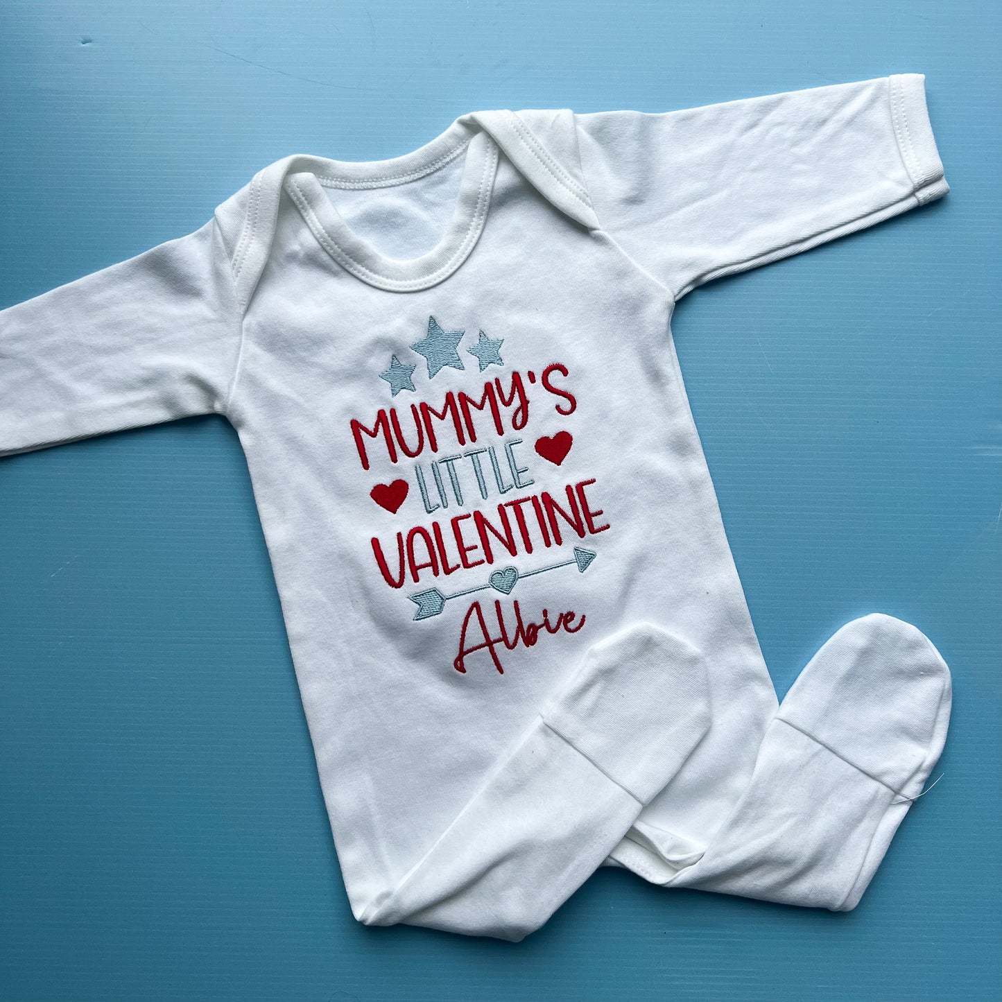 White babies romper with mummy’s little valentine embroidered on the front 