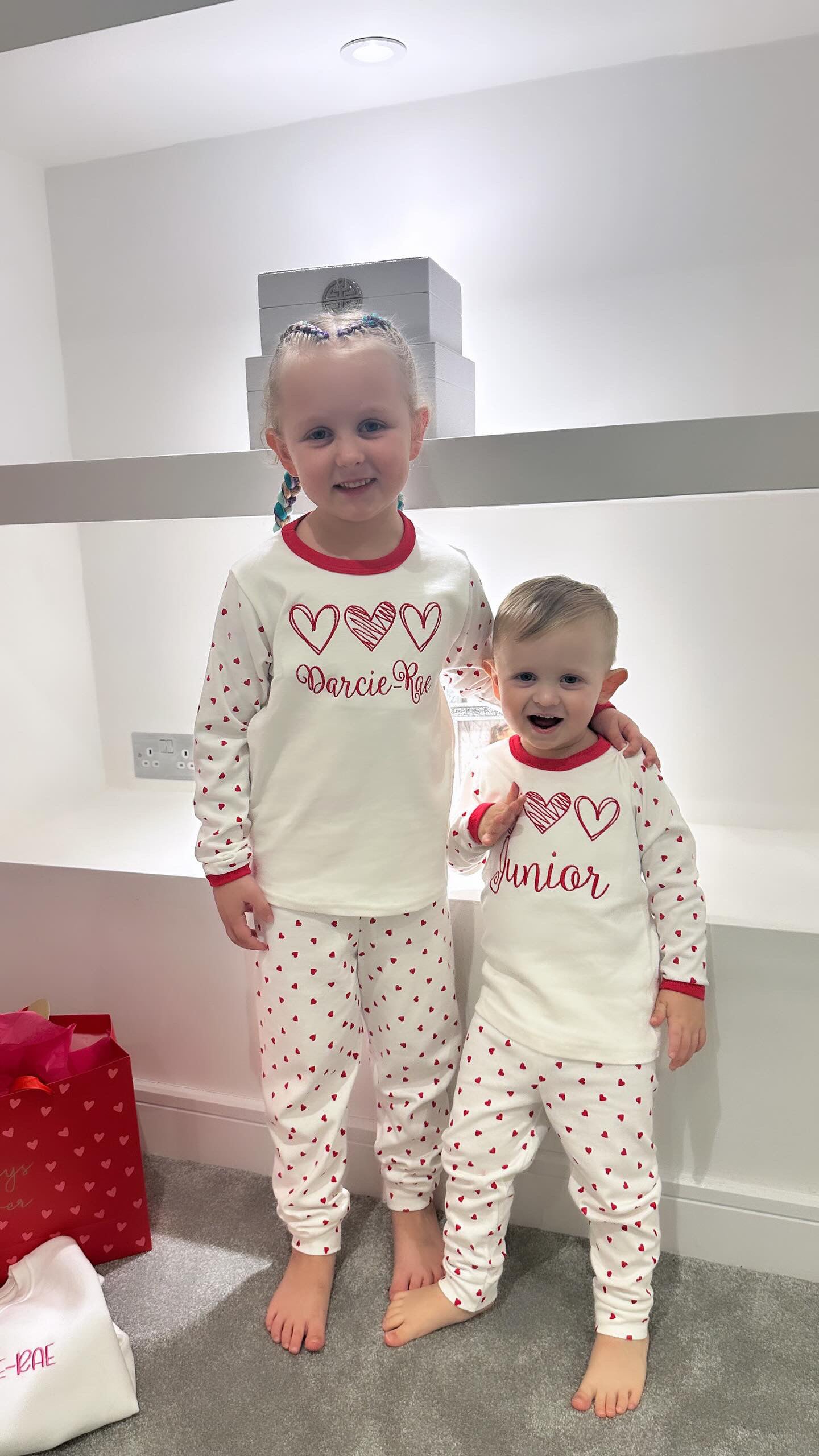 Kids red and white valentine's pjs or  pyjamas with children's names embroidered personalisation. 3 heart Valentine’s Pyjamas. Great for 1st valentines day.