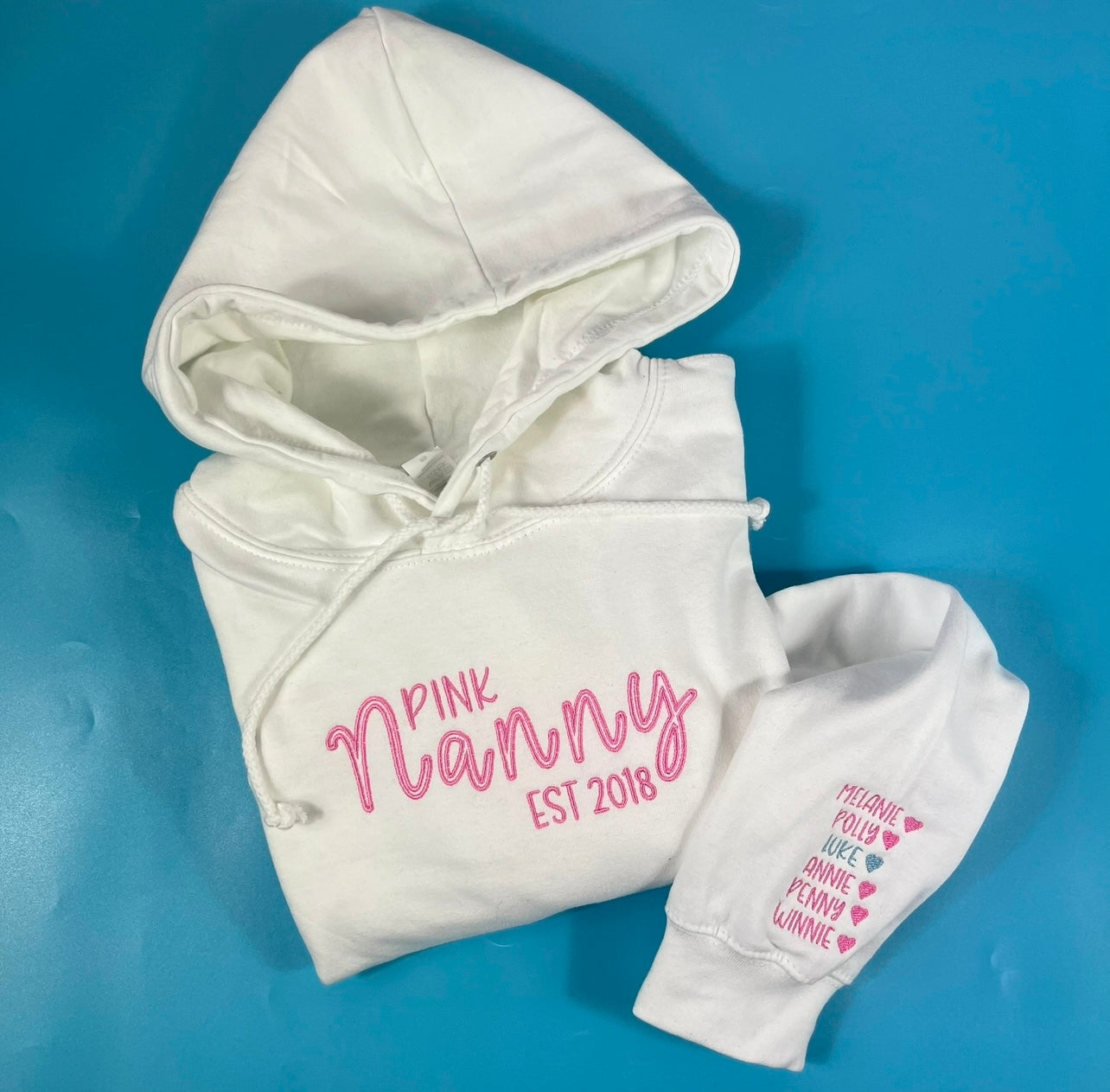 White hoodie with pink text on a blue background