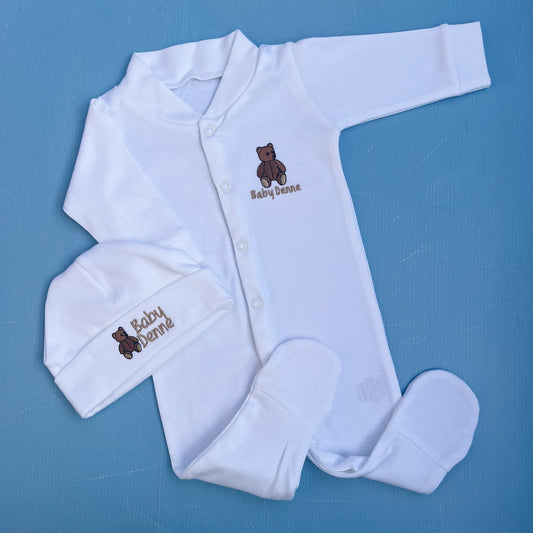 White baby outfit with embroidered teddy bear and 'Baby Bernie' text on a blue background