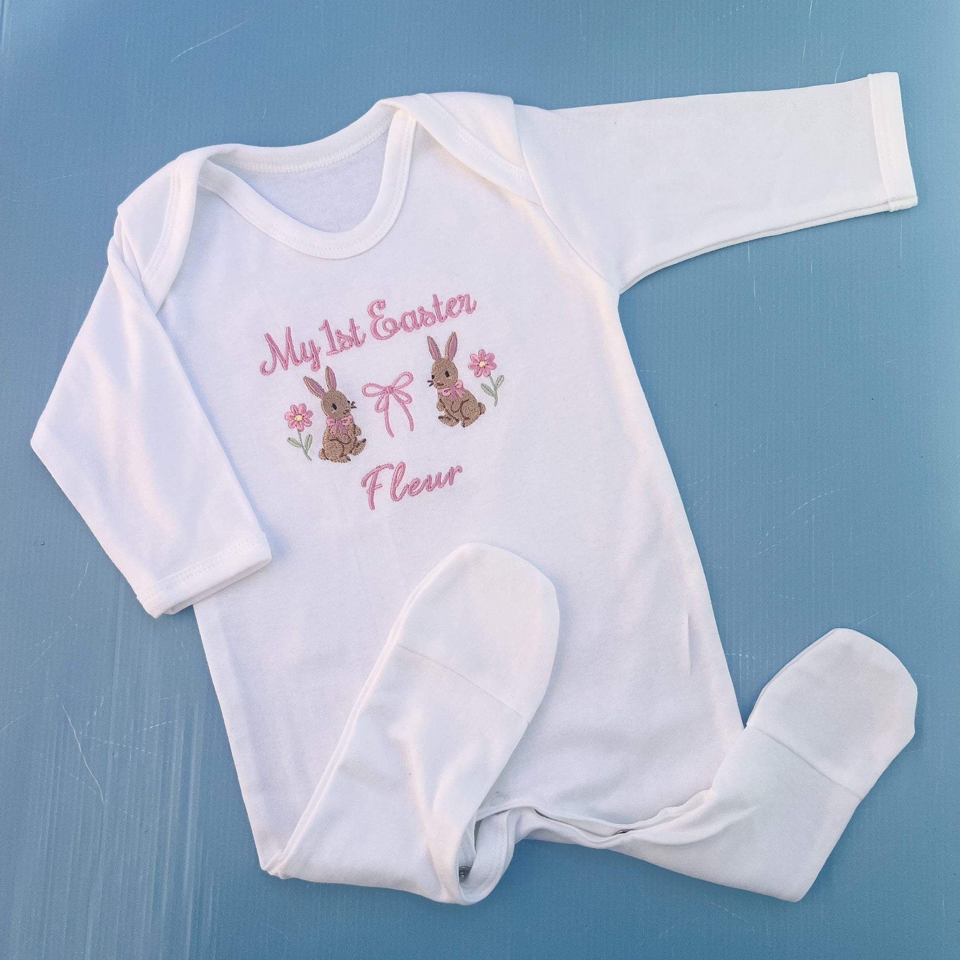 Baby romper with my first Easter embroidered in pink with a bunny, bow and some flowers 