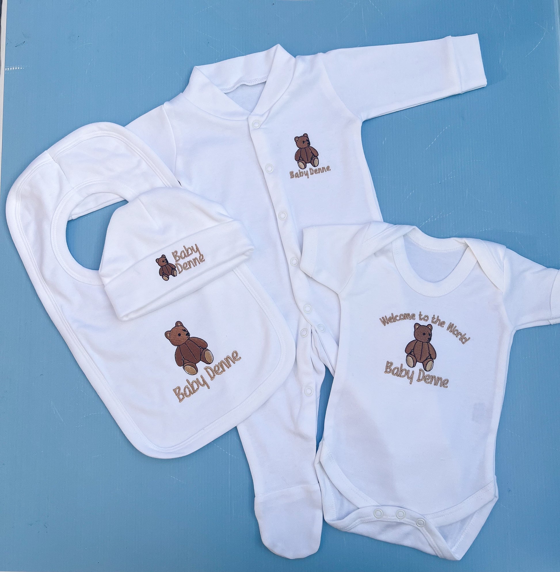 Baby set with babygrow, hat, vest and bib all with a traditional bear embroidery 