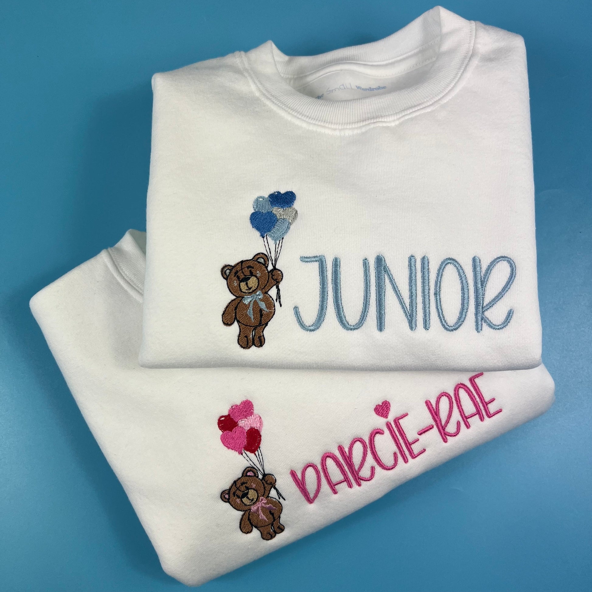 Jumpers with a teddy bear holding love heart balloons embroidered on the front with child’s name 