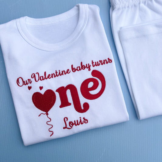 White shirt with red text and heart design on a blue background