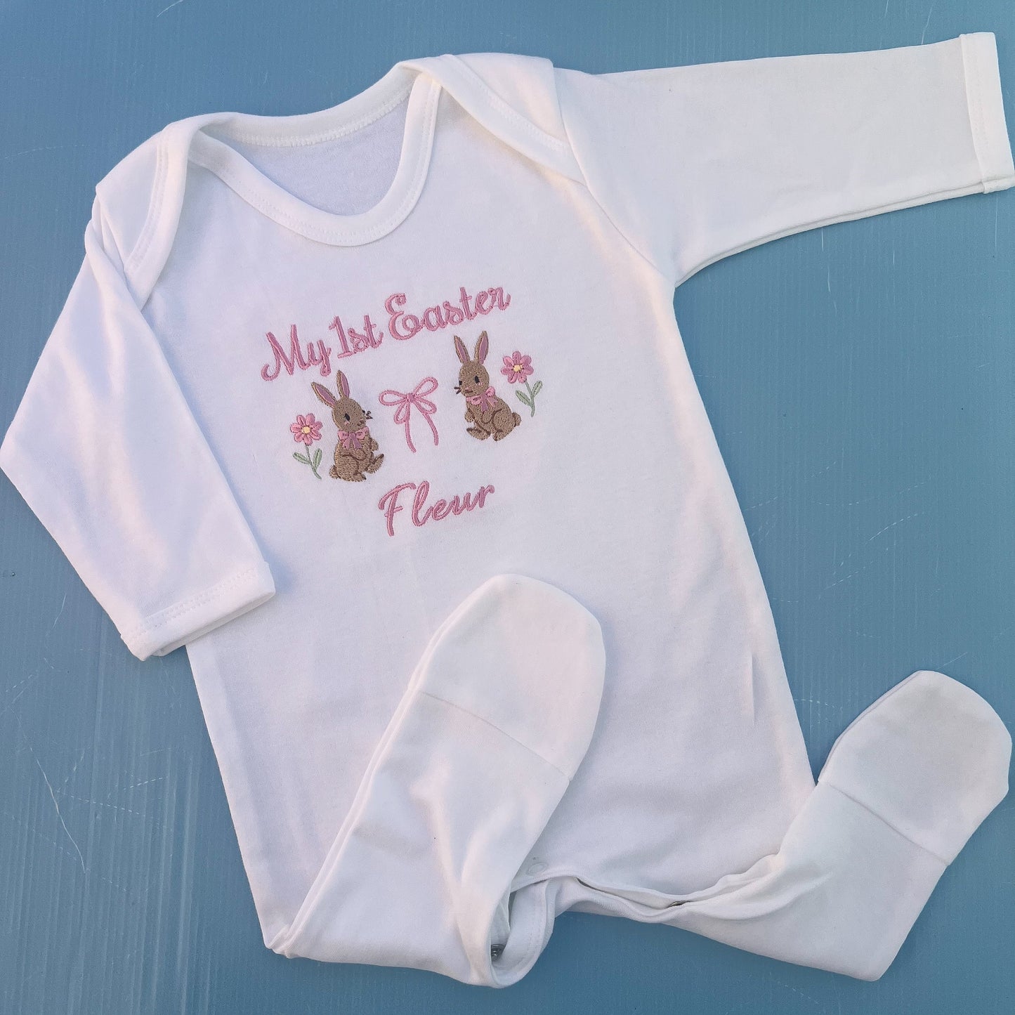 Baby romper with my first Easter embroidered in pink with a bunny, bow and some flowers 