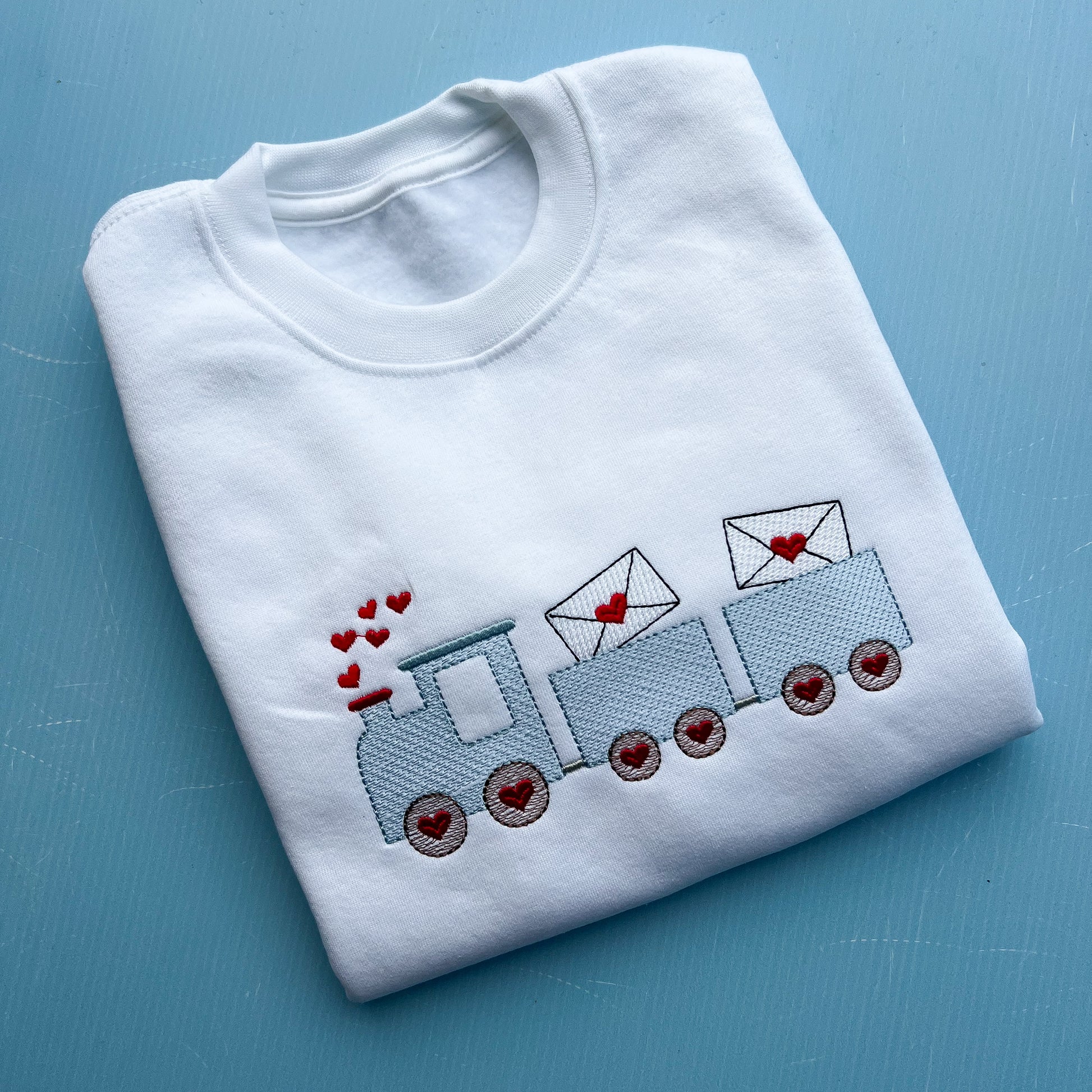 Love Train Valentines /Tshirt Sweatshirt Is a cute love train embroidered onto a white sweatshirt 