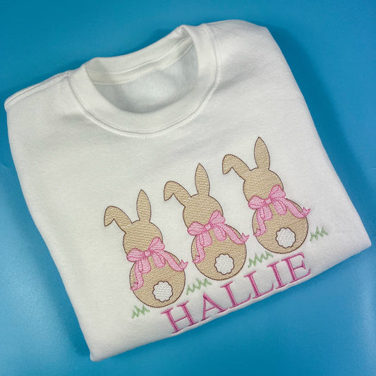 3 bunniess embroidered on a sweatshirt with pink bows and child’s name 