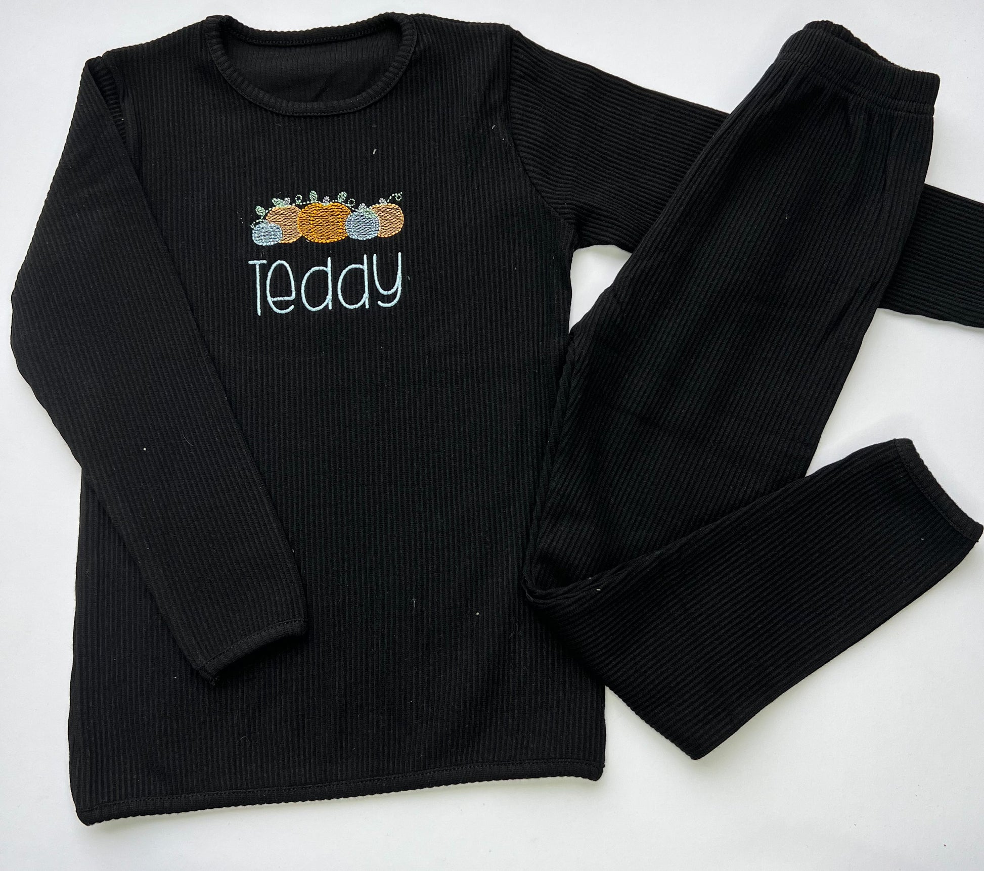 black loungwear with 5 pumpkin design and childs name in embroidery